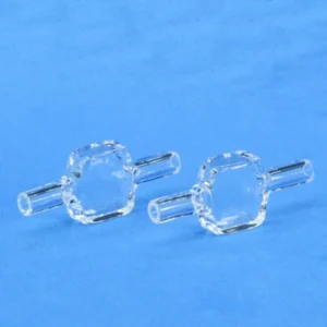Two clear, 10mm pathlength quartz fluorescence flow cells, featuring a hexagonal central body and tubular inlets/outlets, displayed on a solid blue background.