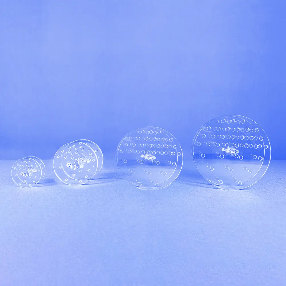 Quartz Gas Diffuser | Fused Silica Furnace Tube Gas Distributor 2 Four clear circular quartz perforated plates, varying in size, showcasing the internal components of a gas diffuser.