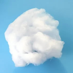 A slightly pulled apart, airy clump of white high-purity quartz wool, showcasing its fibrous texture on a blue surface