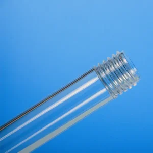 A close-up view of the threaded ends of two quartz tubes, highlighting the precision of the external screw threads on a blue surface.