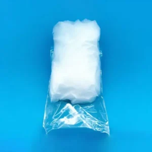 A rectangular block of compressed high-purity quartz wool, partially encased in clear plastic packaging, on a blue background.