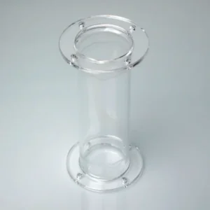 A clear quartz tube with flanges on both ends, positioned diagonally on a reflective light-colored surface, showcasing its cylindrical form and secure flange design.