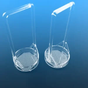 A close-up, angled view of two clear quartz dipping baskets, highlighting their perforated bottom and the smooth, high-purity quartz material.