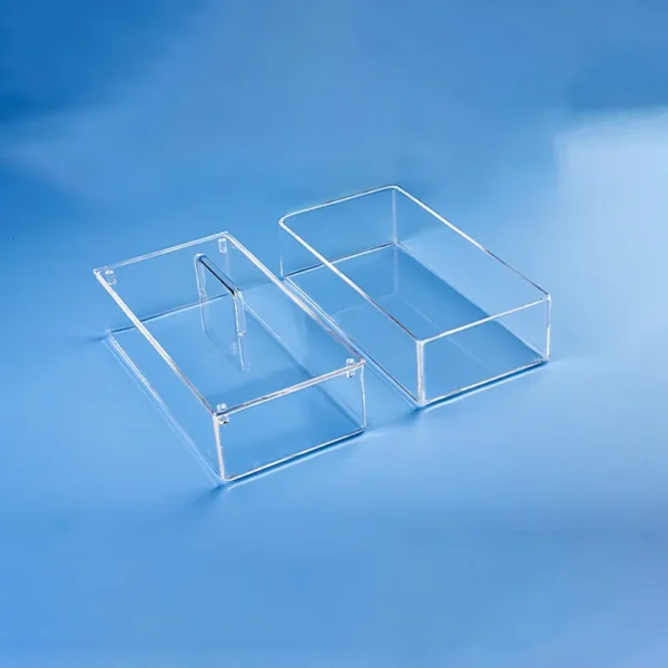 Two clear, rectangular custom fused quartz tanks/containers on a blue background, showcasing their precise construction.