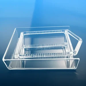 A clear, rectangular high-purity slotted quartz boat (smaller) positioned inside a larger, flat quartz carrier tray,