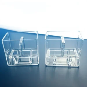 A clear, empty square quartz tank next to a quartz wafer cleaning tank with an integrated internal rack, illustrating the two main types.